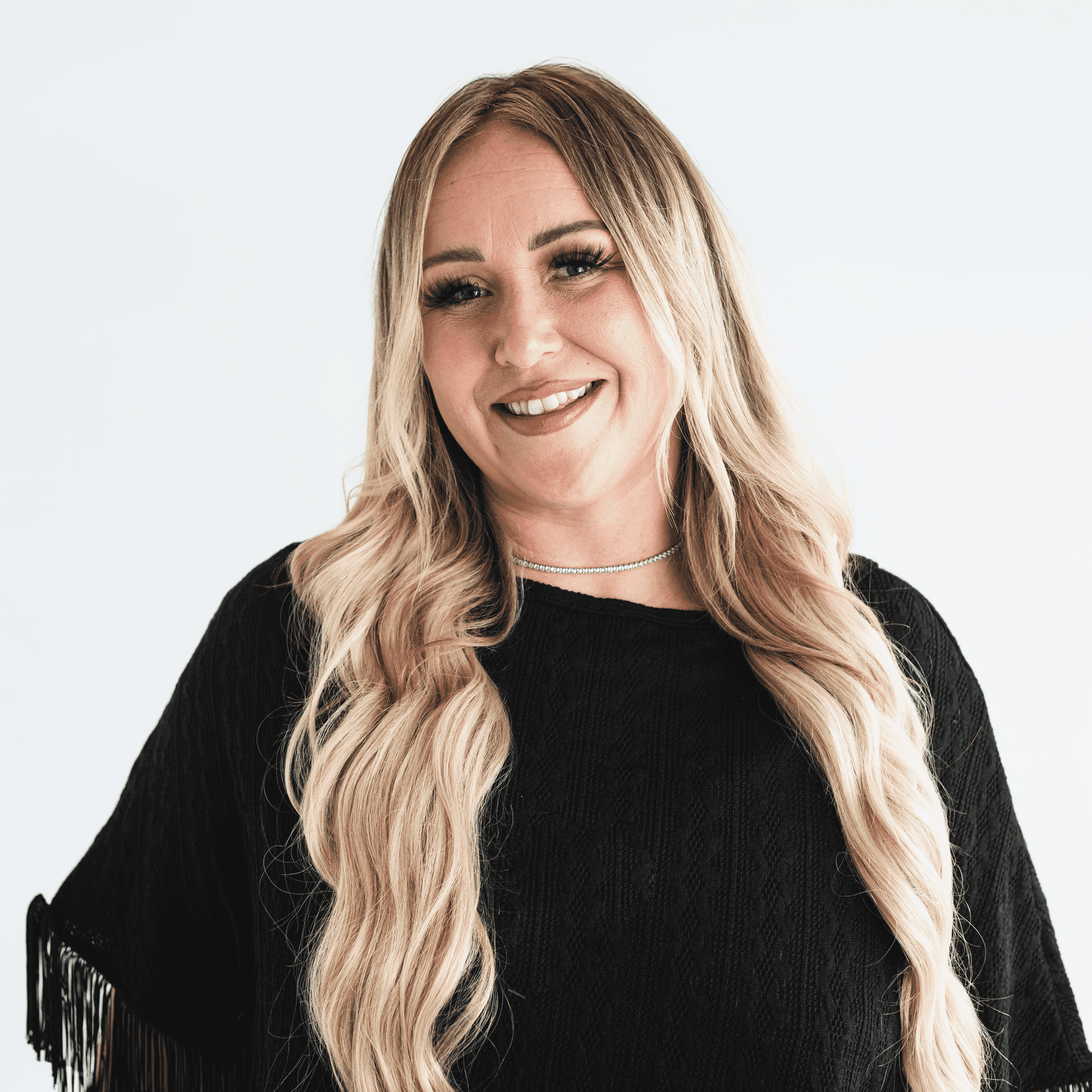Portrait of Jaqualyn Shartle, a professional stylist at The Capital Salon & Suites, showcasing their expertise and style.