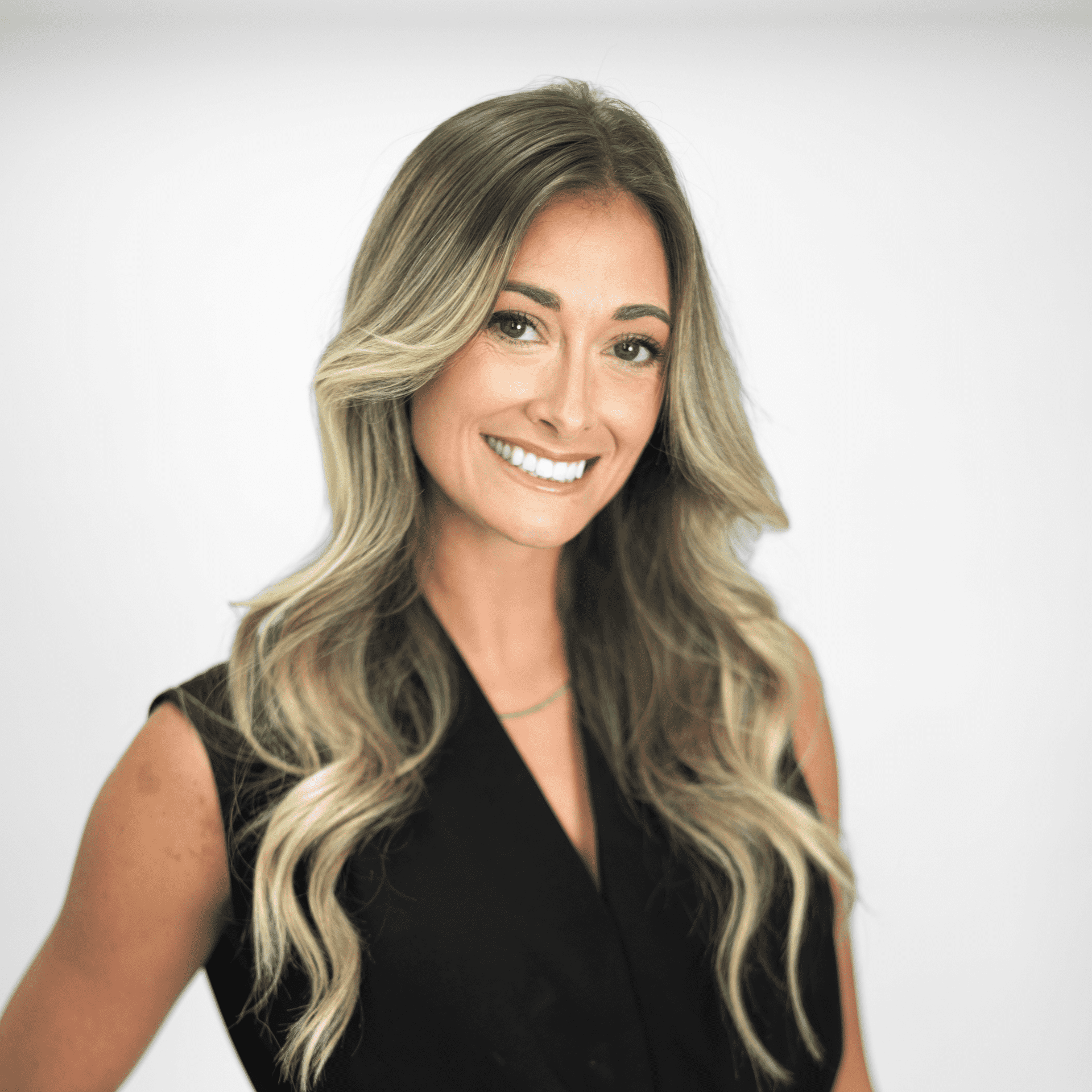Portrait of Lacee Akins, a professional stylist at The Capital Salon & Suites, showcasing their expertise and style.