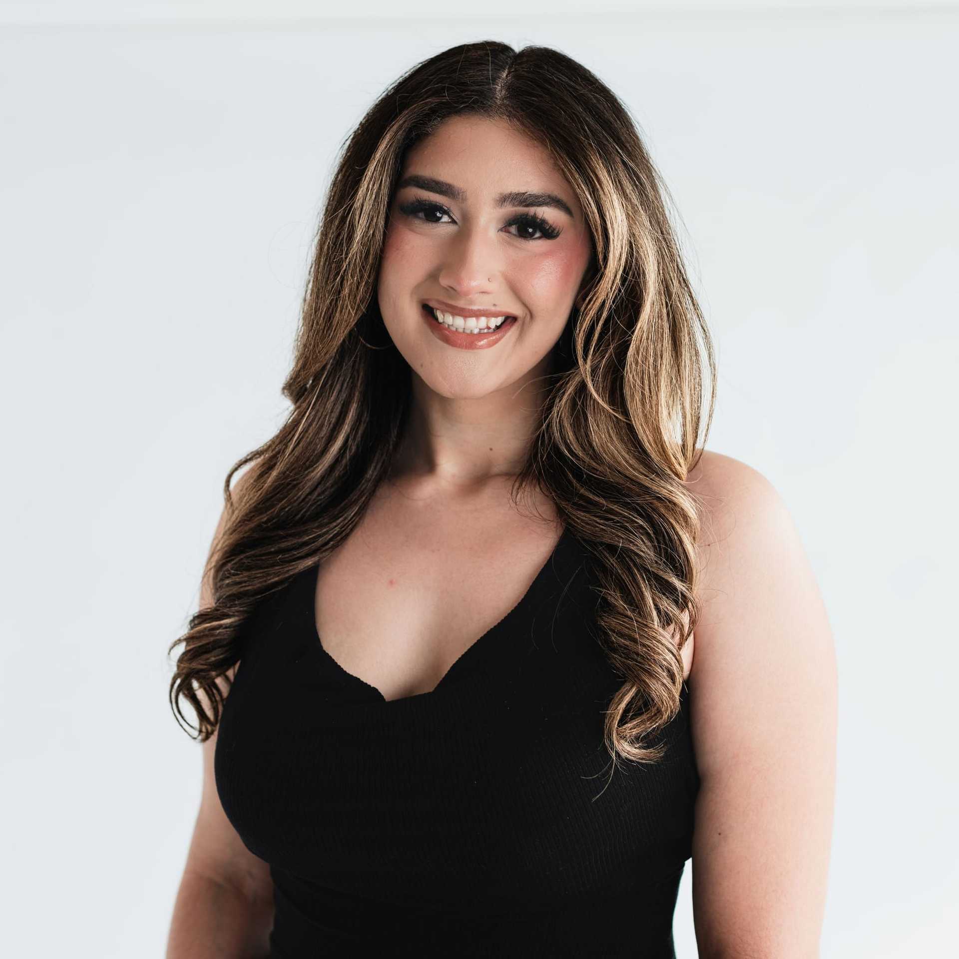 Portrait of Elizabeth Herrera, a professional stylist at The Capital Salon & Suites, showcasing their expertise and style.