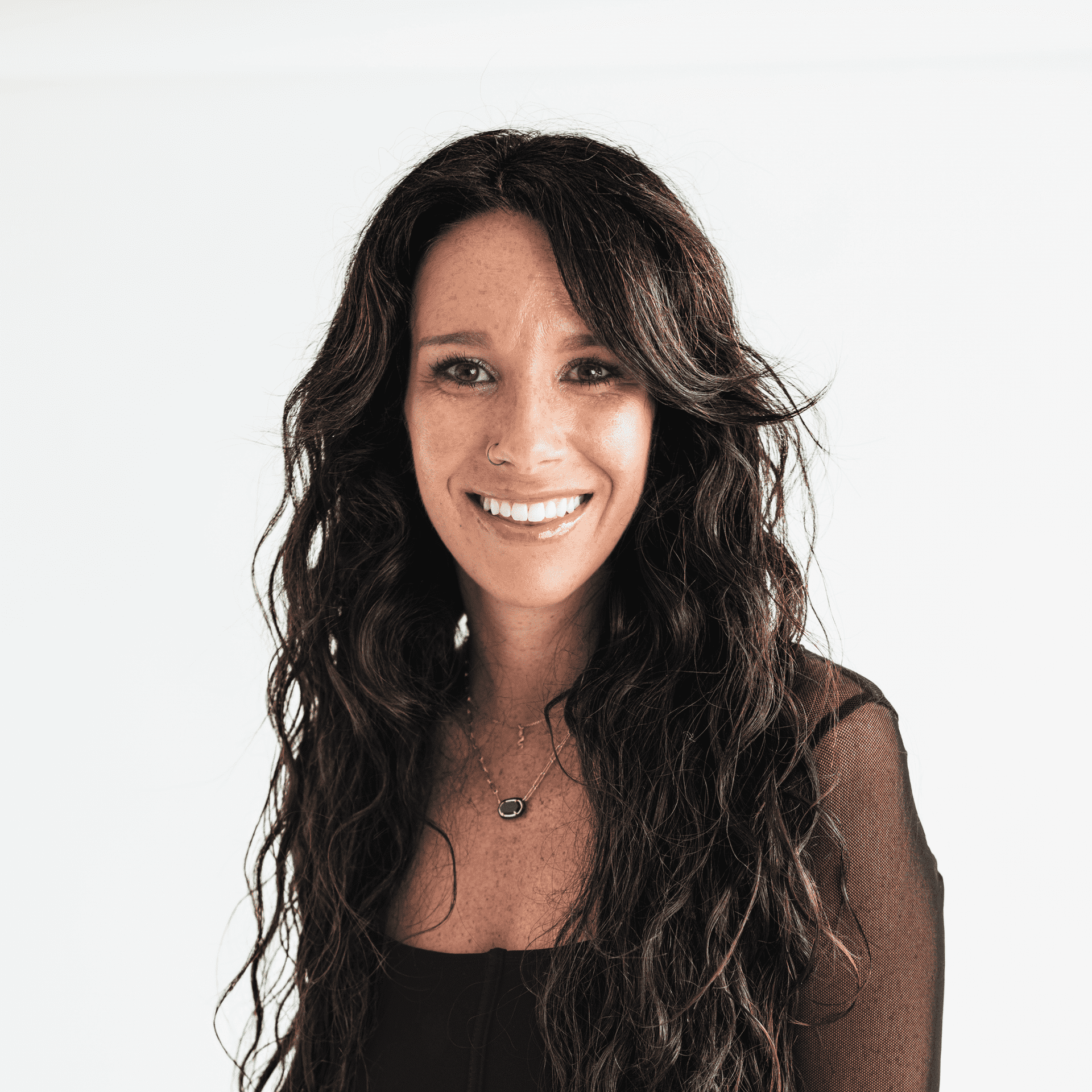 Portrait of Michaela Delmez, a professional stylist at The Capital Salon & Suites, showcasing their expertise and style.