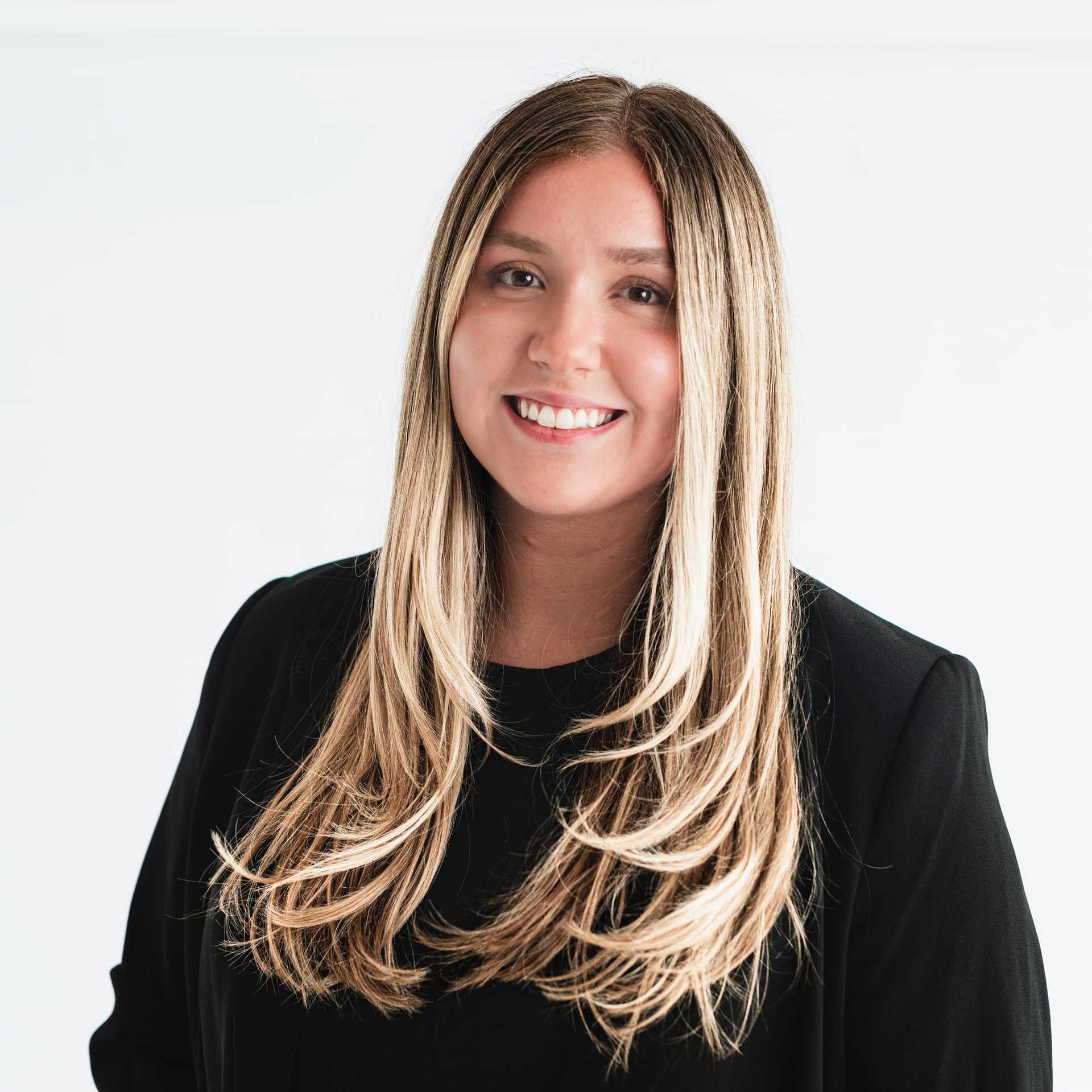 Portrait of Jessie Goodman, a professional stylist at The Capital Salon & Suites, showcasing their expertise and style.
