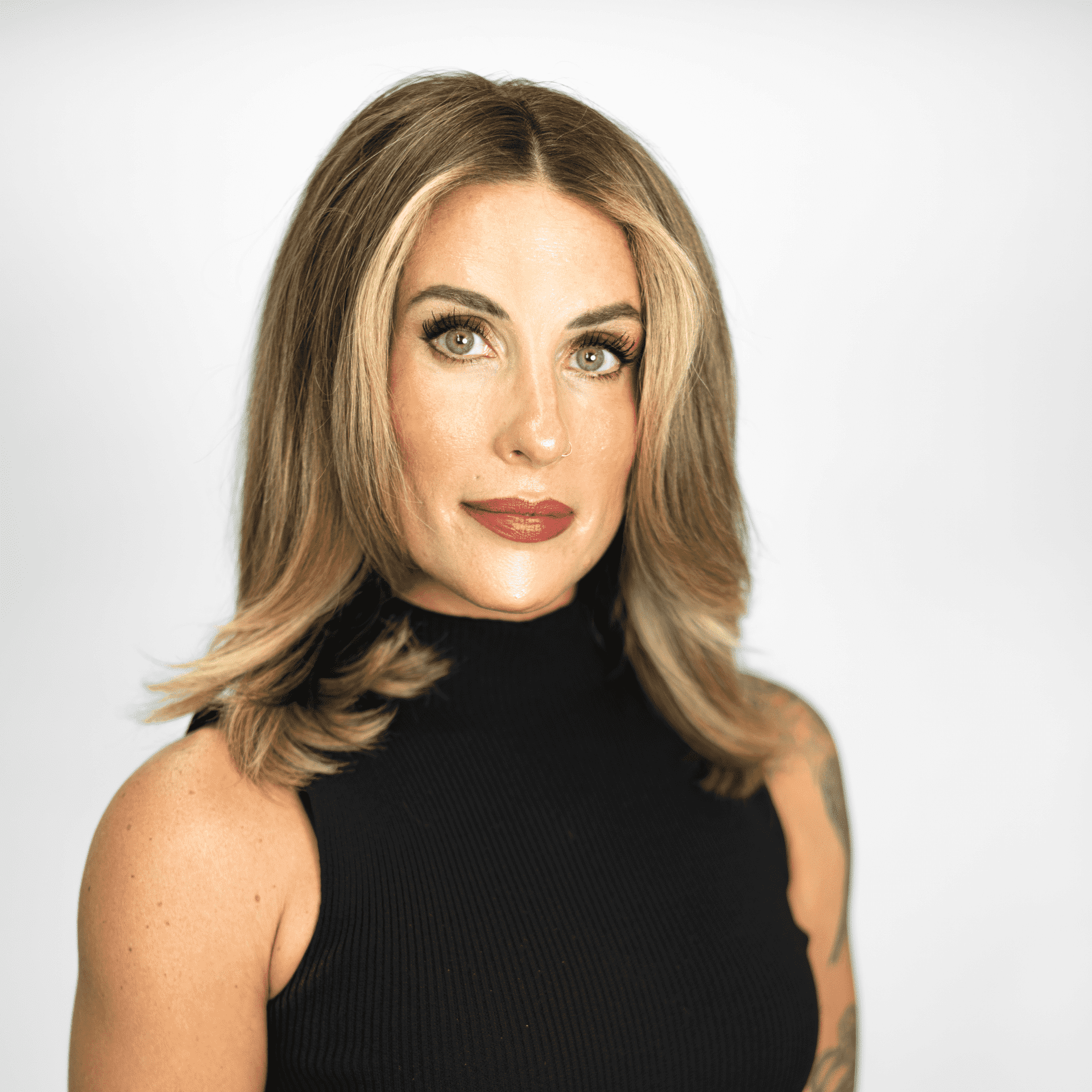 Portrait of Logan Reed, a professional stylist at The Capital Salon & Suites, showcasing their expertise and style.