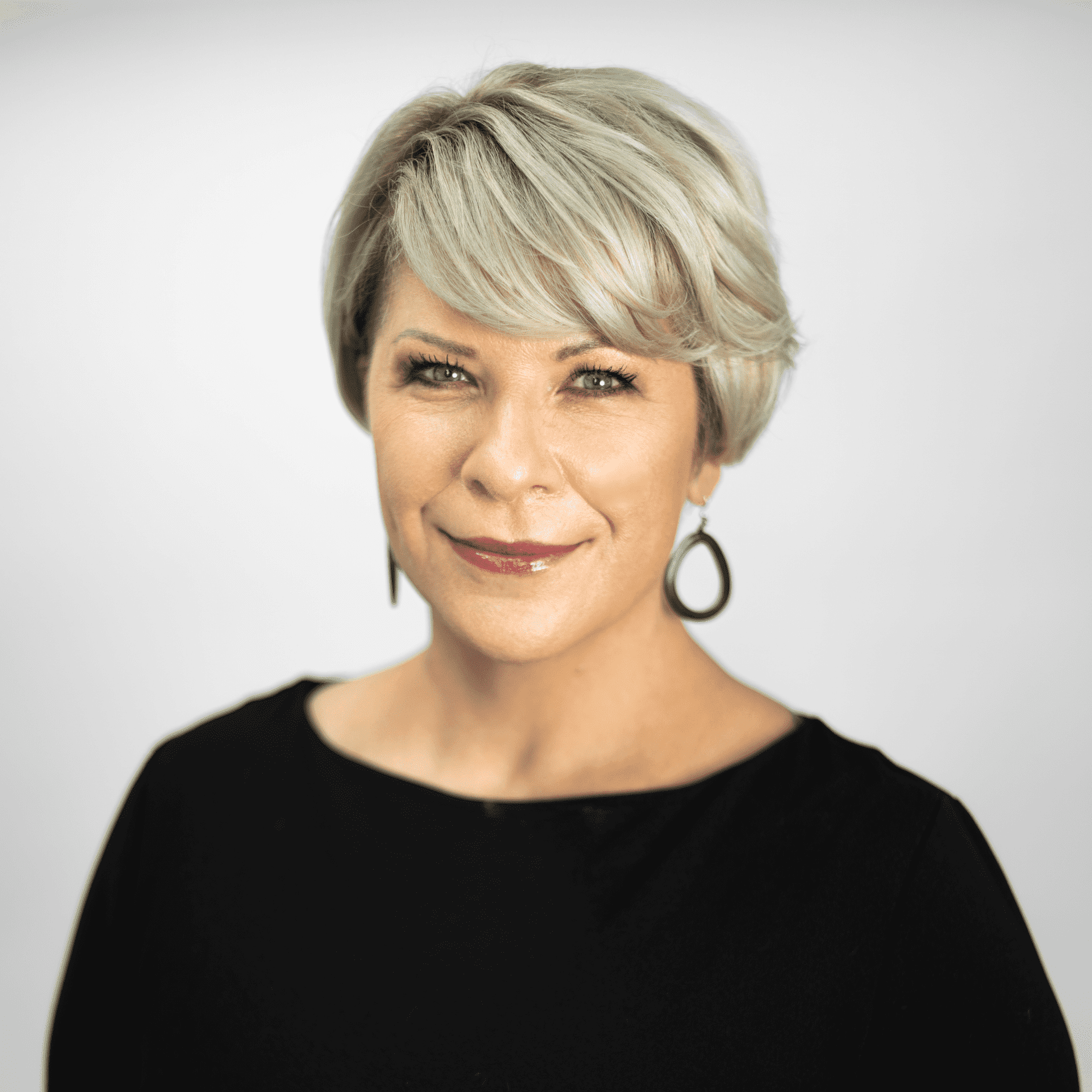 Portrait of Anna Jones, a professional stylist at The Capital Salon & Suites, showcasing their expertise and style.