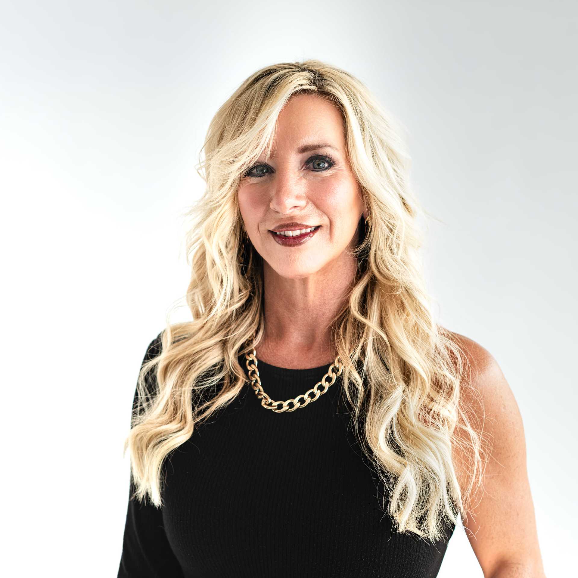 Portrait of Stephanie Holland, a professional stylist at The Capital Salon & Suites, showcasing their expertise and style.