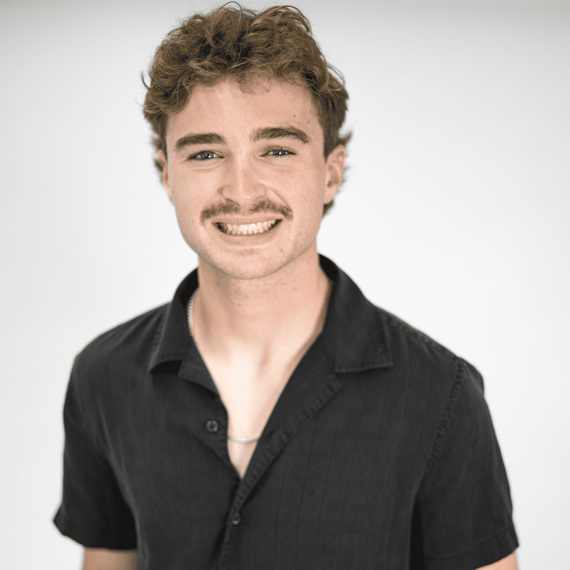 Portrait of Parker Moore, a professional stylist at The Capital Salon & Suites, showcasing their expertise and style.
