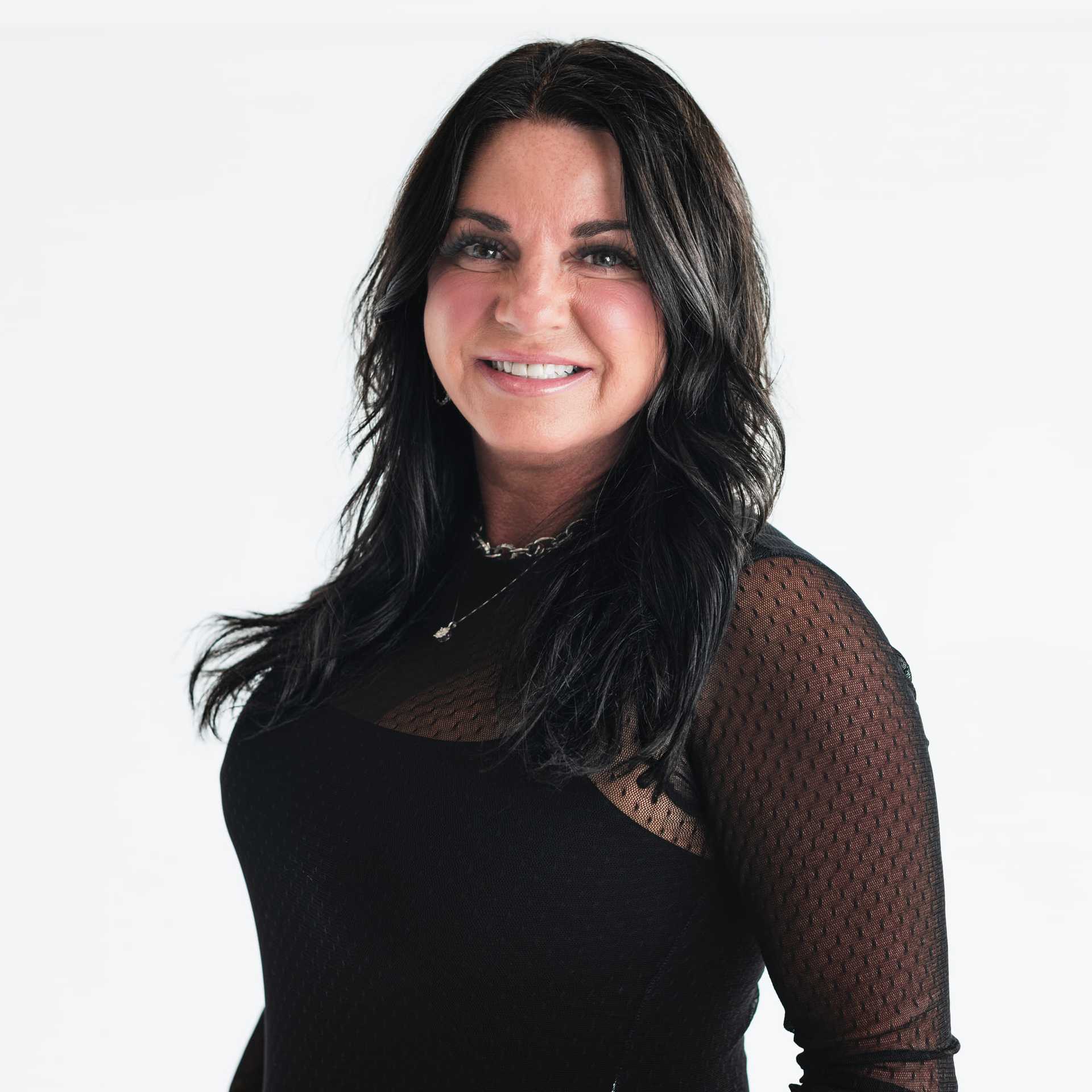Portrait of Amy Lester, a professional stylist at The Capital Salon & Suites, showcasing their expertise and style.