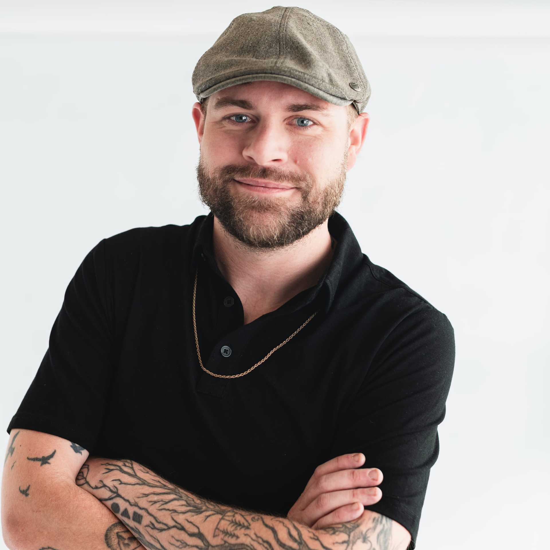 Portrait of Ryan Holtmeyer, a professional stylist at The Capital Salon & Suites, showcasing their expertise and style.