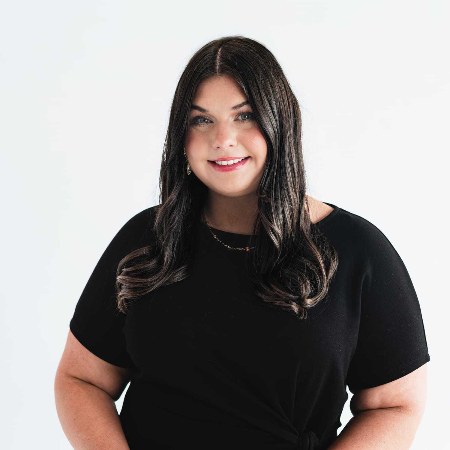 Portrait of Becca Tolbert-Stacy, a professional stylist at The Capital Salon & Suites, showcasing their expertise and style.