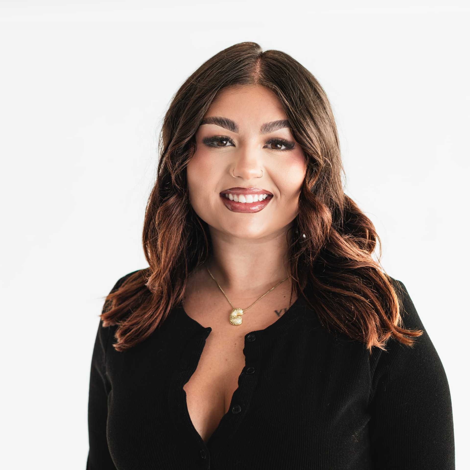 Portrait of Ciera Rosso, a professional stylist at The Capital Salon & Suites, showcasing their expertise and style.