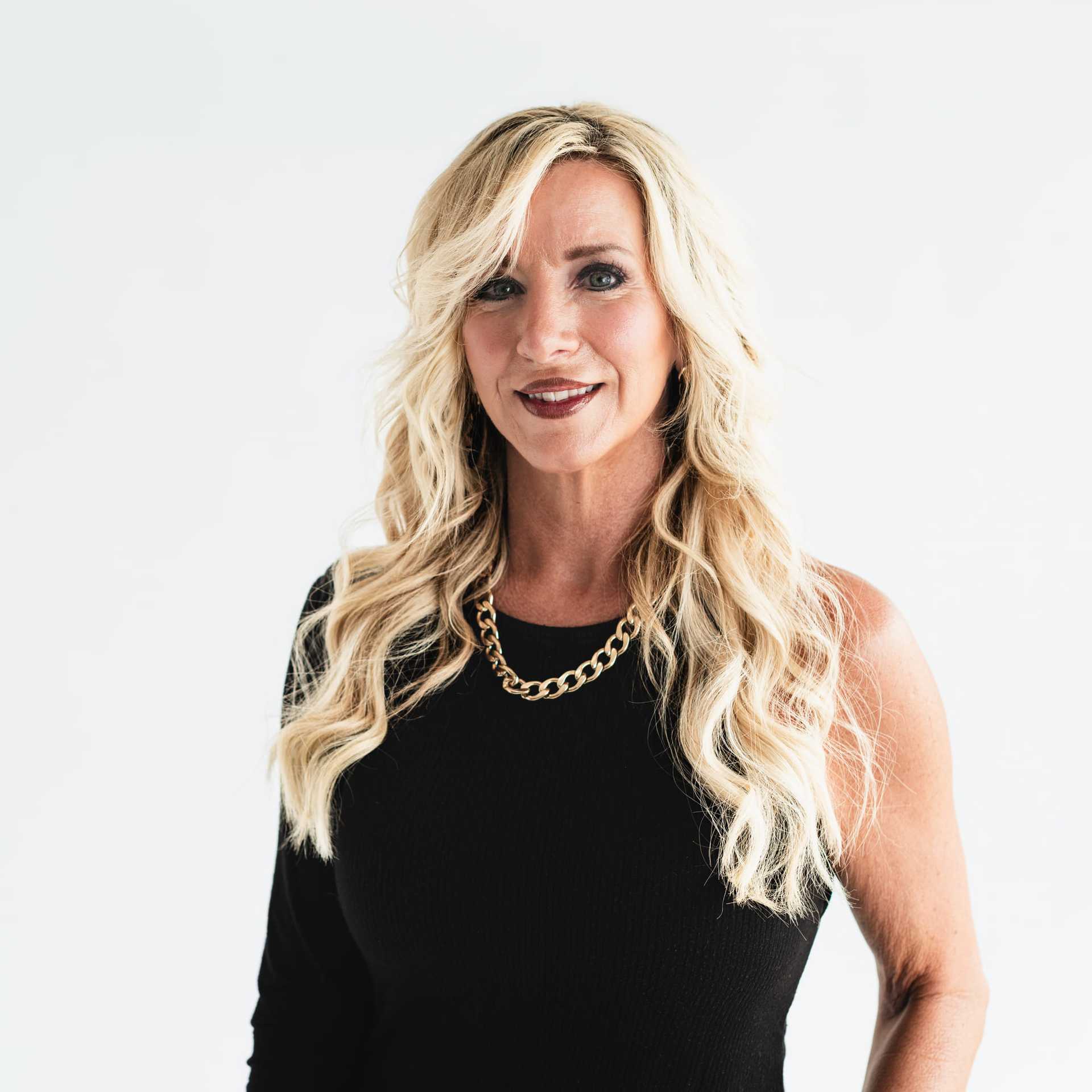 Portrait of Stephanie Holland, a professional stylist at The Capital Salon & Suites, showcasing their expertise and style.