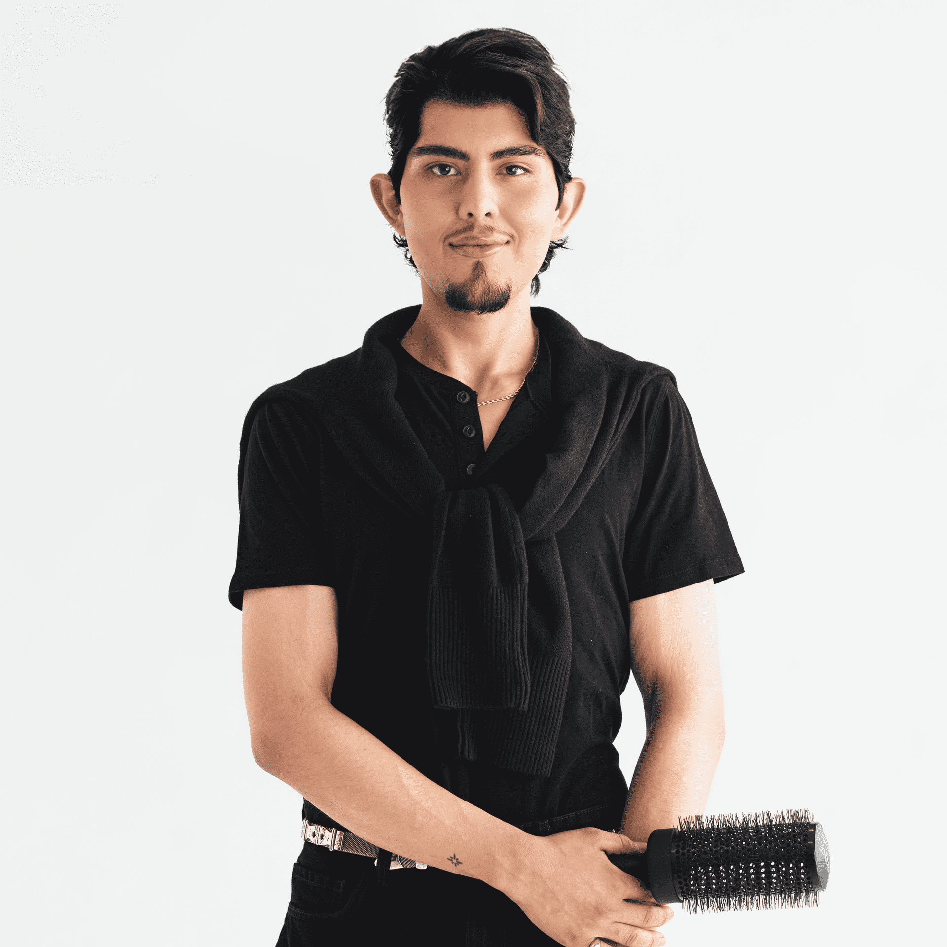 Portrait of Omar DeLeon, a professional stylist at The Capital Salon & Suites, showcasing their expertise and style.